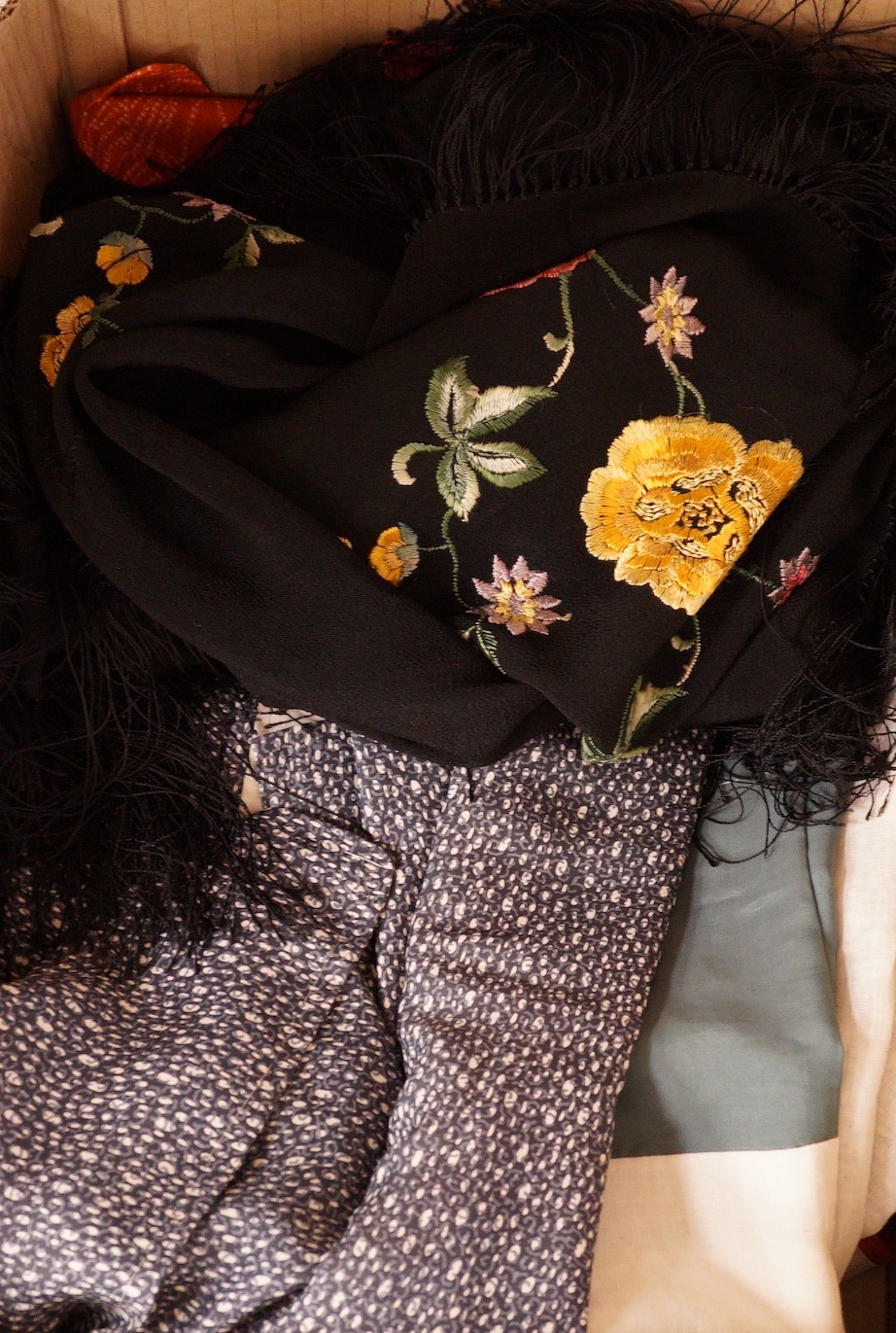 An assortment of clothing: two kimonos and a throw